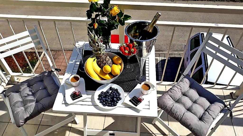 a table with a bowl of fruit on a balcony at Violet Red Yellow Apartments in Korčula