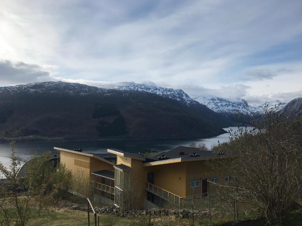 a house with a view of a lake and mountains at Hordatun Apartments in Røldal