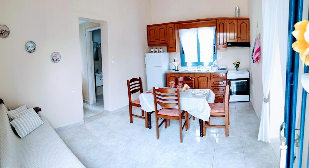 a kitchen with a table and chairs in a kitchen at Zoes House in Kyra Panagia
