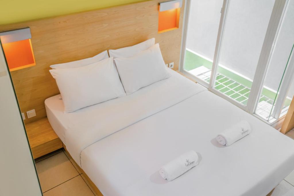 Letto o letti in una camera di LeGreen Suite Poso
