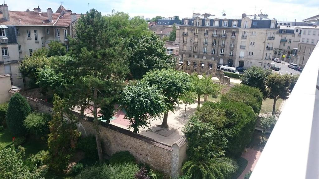 une vue d'une ville avec des arbres et des bâtiments dans l'établissement CENTRE-CATHEDRALE-CORDELIERS avec garage, à Reims