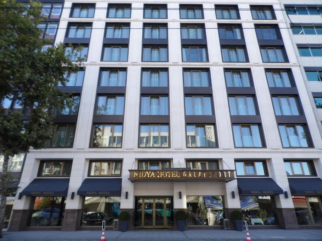 a large white building with a sign on it at Nidya Hotel Galataport in Istanbul