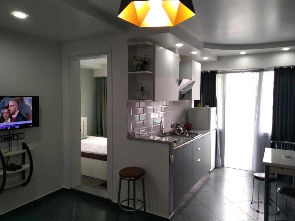 a kitchen with a sink and a counter in a room at Apartment Eteri in Batumi