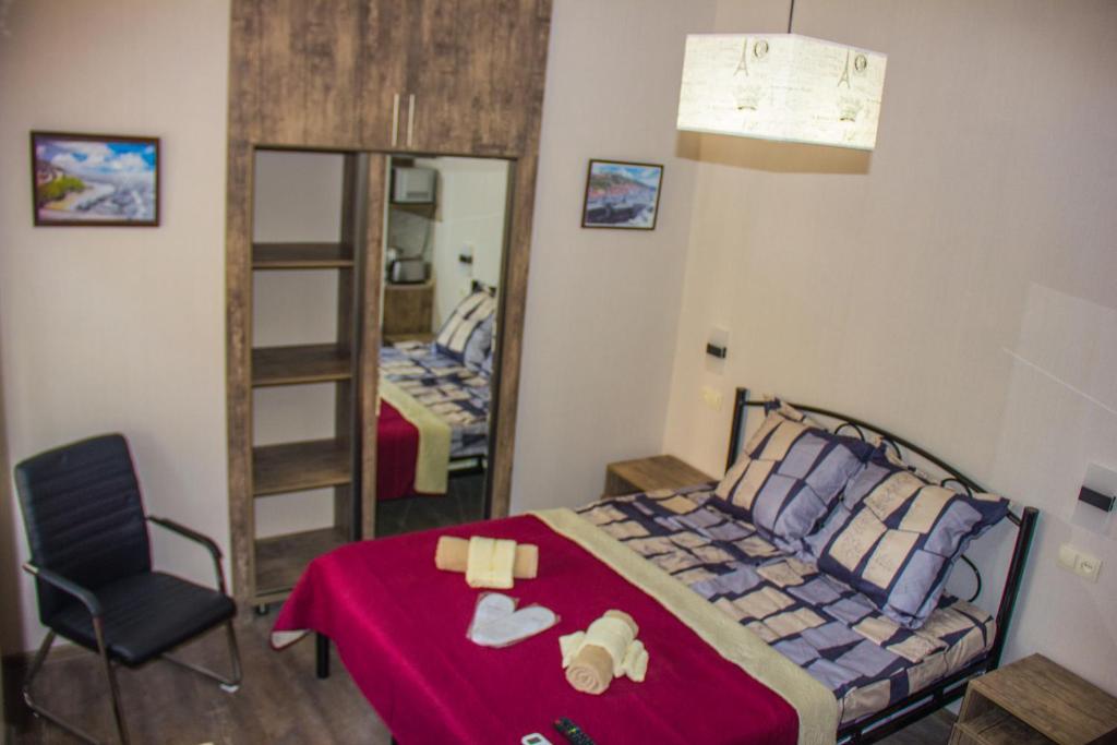 um quarto com uma cama, uma cadeira e um espelho em Old Tbilisi apartments em Tbilisi