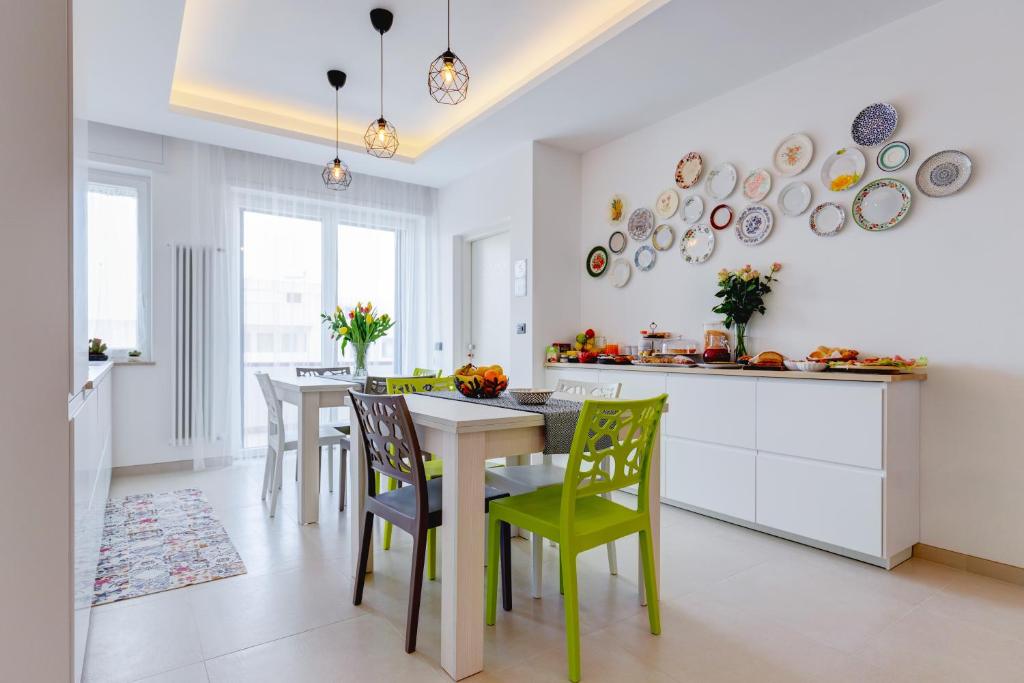 a kitchen and dining room with a table and chairs at B&B Rocamatura - Adults only in Otranto