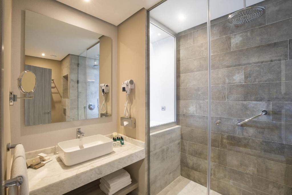 a bathroom with a sink and a shower at Marina Bay City Center in Tangier