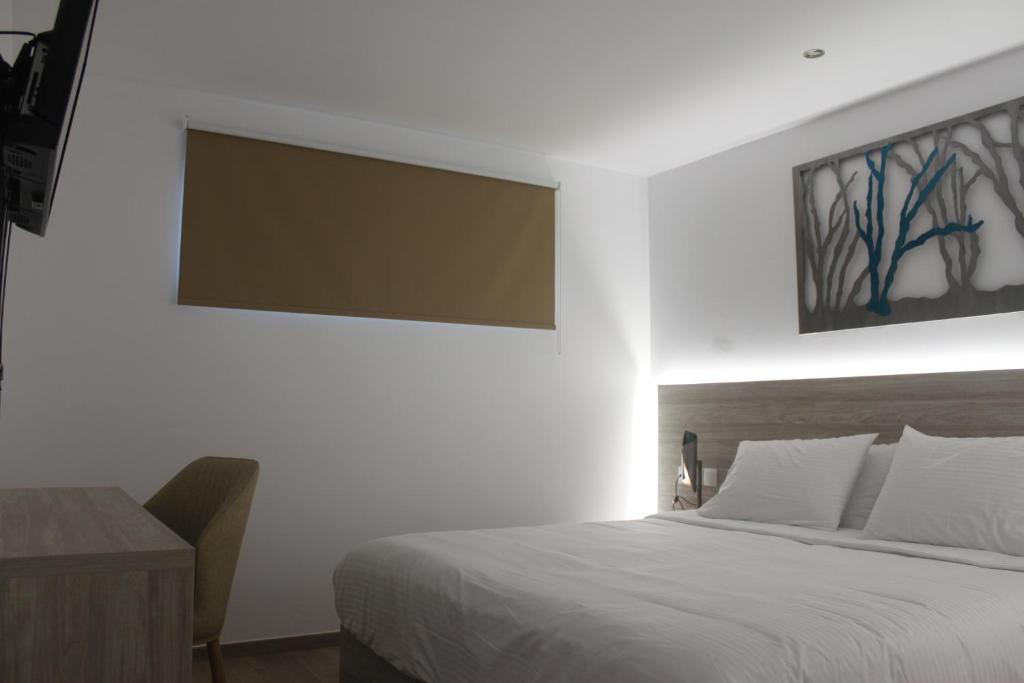 Postel nebo postele na pokoji v ubytování Vallian Village Hotel