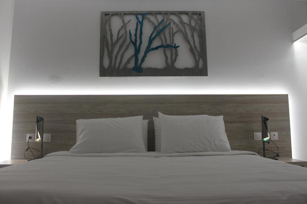 Postel nebo postele na pokoji v ubytování Vallian Village Hotel