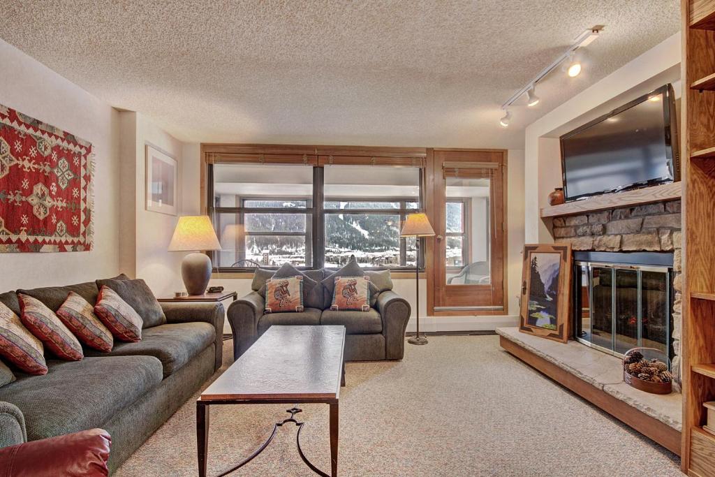 a living room with a couch and a fireplace at VS643 Square Condo in Copper Mountain