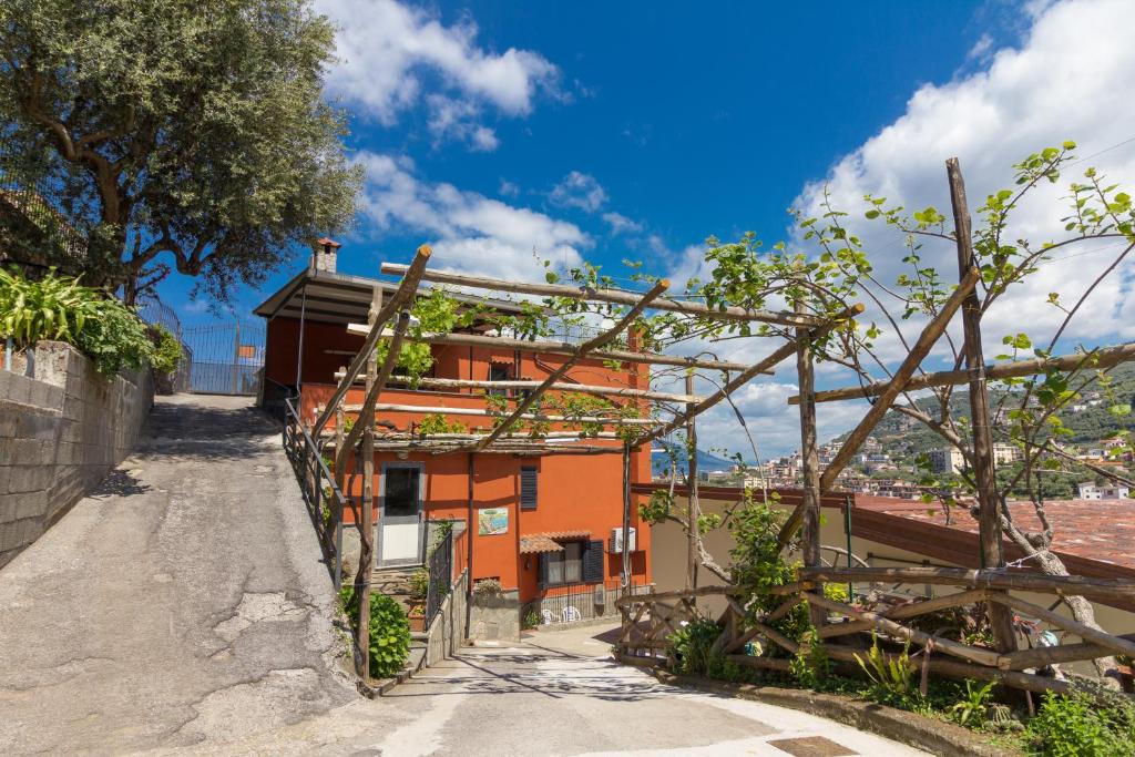 an orange house on the side of a road at Casale Ceppone in Vico Equense