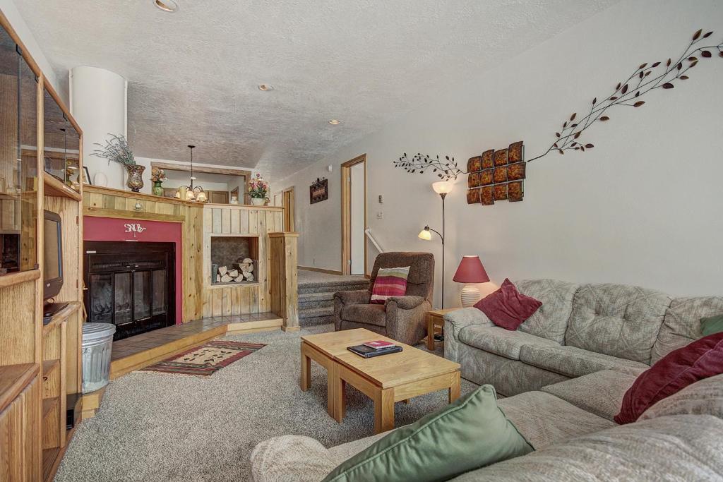 a living room with a couch and a fireplace at 2062 The Pines Condo in Keystone