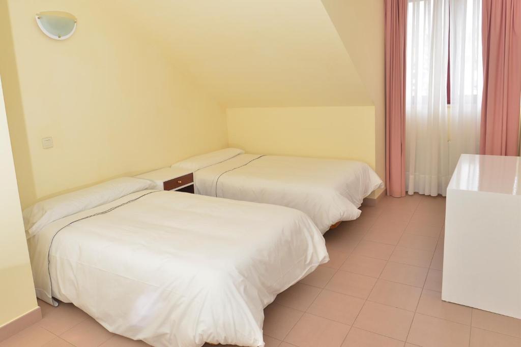A bed or beds in a room at Apartamentos Marina