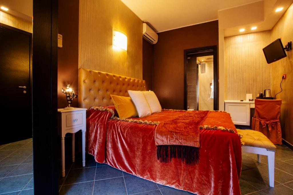 a bedroom with a bed with a red comforter at B&B Il Parco in Monterosso al Mare