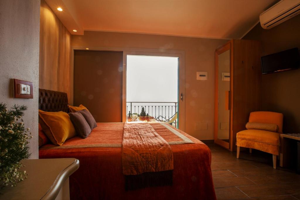 a bedroom with a bed with a large window at B&B Il Parco in Monterosso al Mare