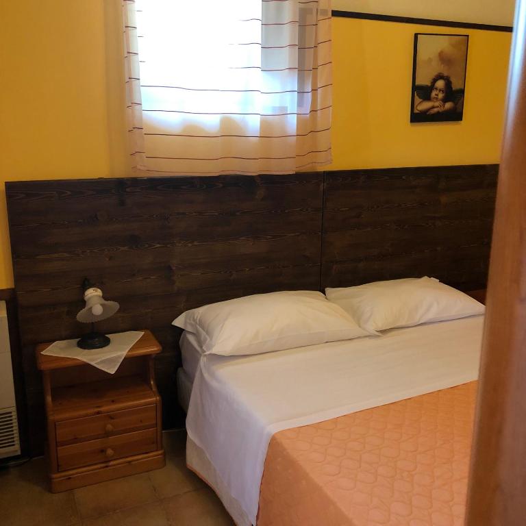 Postel nebo postele na pokoji v ubytování Agriturismo Valle di Chiaramonte
