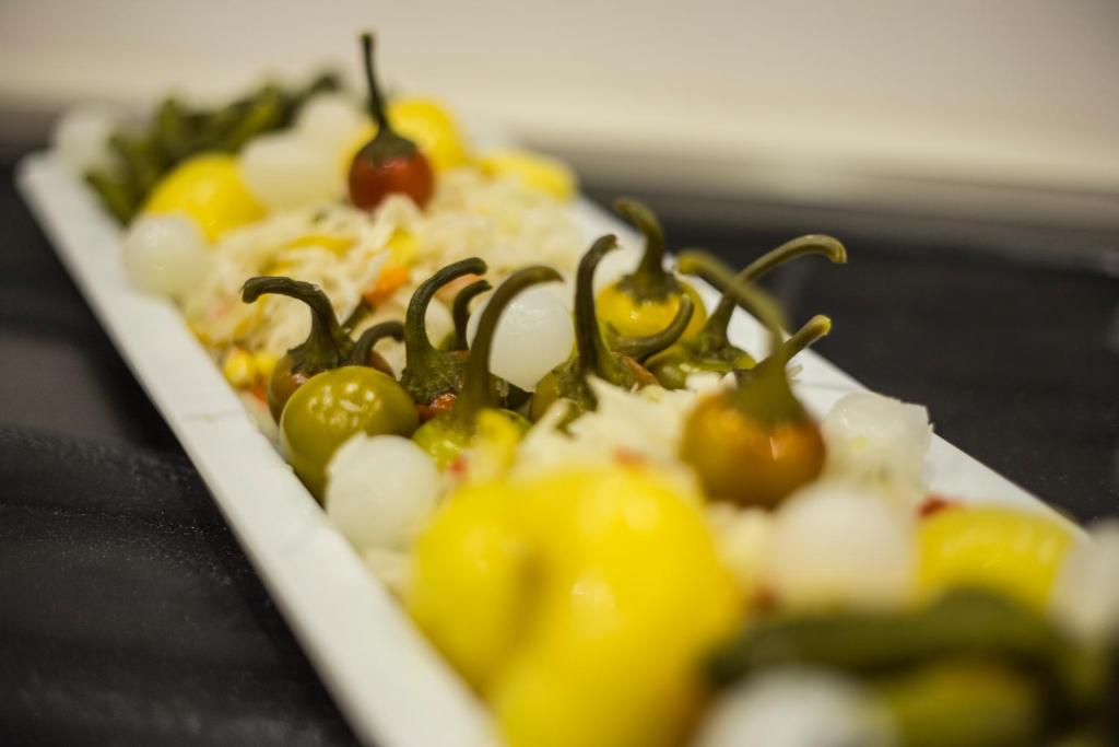 a plate of food with tomatoes and other vegetables at Bükkös Hotel & Spa in Szentendre