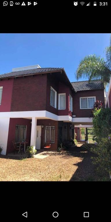 a large red house with a tree in front of it at MAU-MAR in Colón