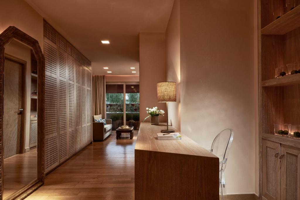 a hallway with a desk and a living room at The Margi in Athens