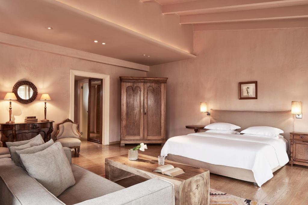 a bedroom with a large white bed and a couch at The Margi in Athens