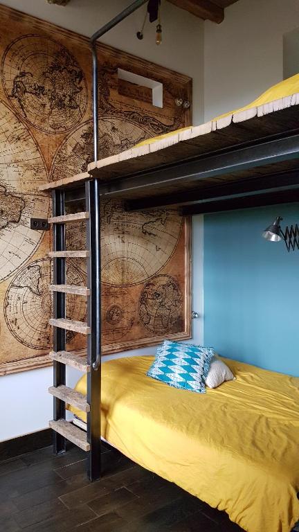 a bedroom with a bunk bed with a map wall at B&B A la Ferme d'Ourches in Cerville