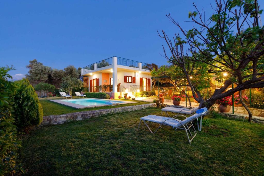 a house with a swimming pool in the yard at Lily's Cottage in Platanes