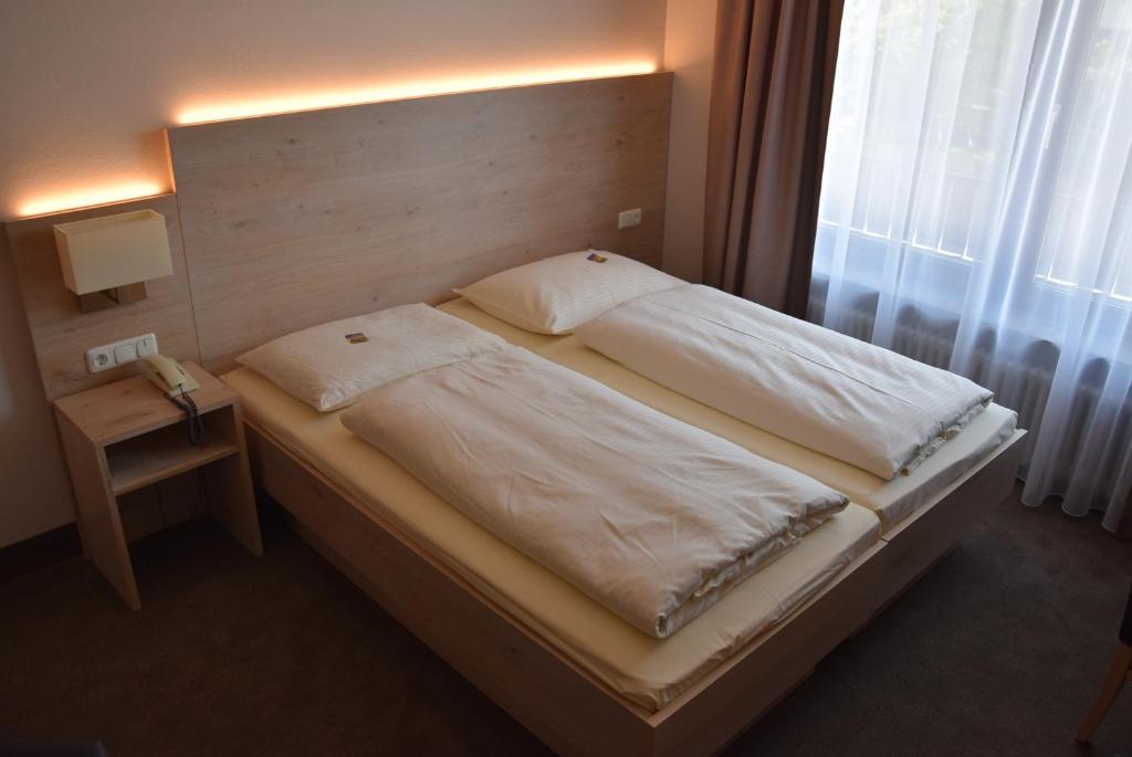 Postel nebo postele na pokoji v ubytování Hotel Lutter