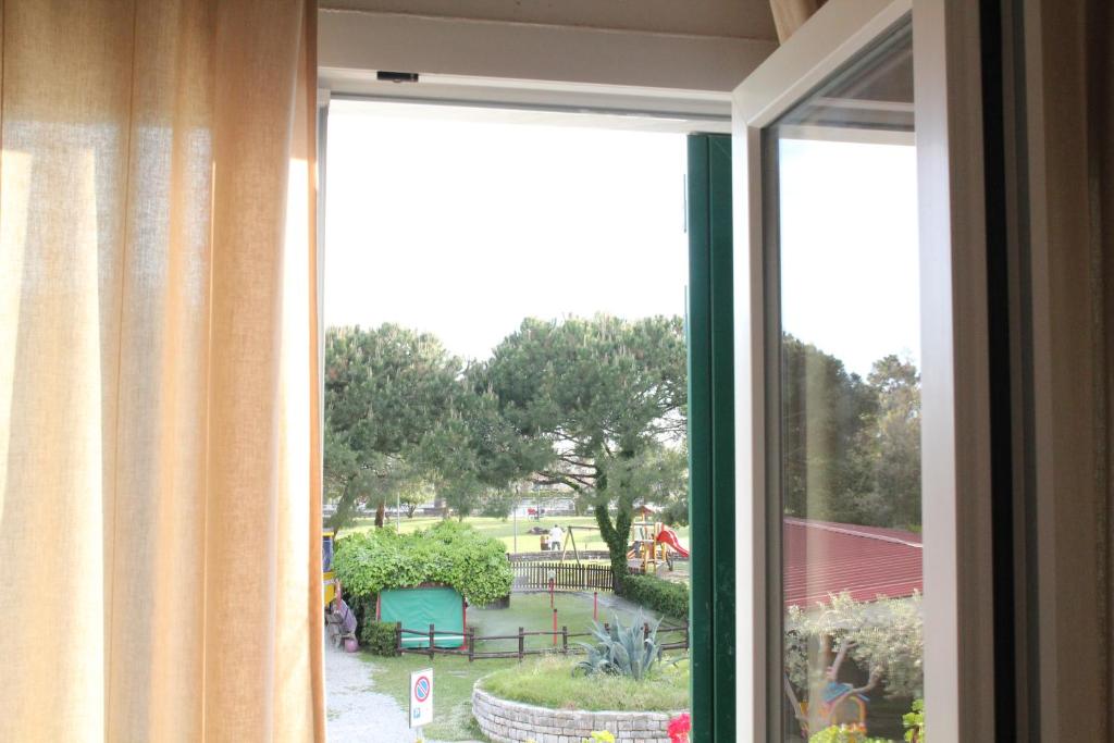 an open window with a view of a park at Appartamenti La corte al Mare in Massa