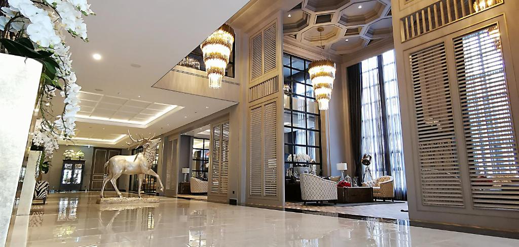 a lobby with a statue of a horse in a building at SN Connx - SHA Plus in Pattaya Central