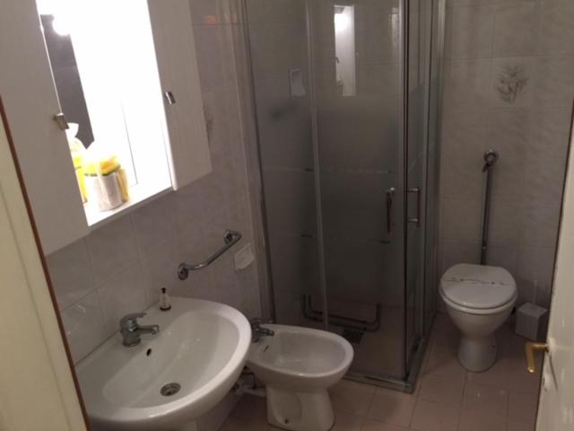 a bathroom with a sink and a toilet and a shower at Residence El Palmar DA COLLA in Lido di Jesolo