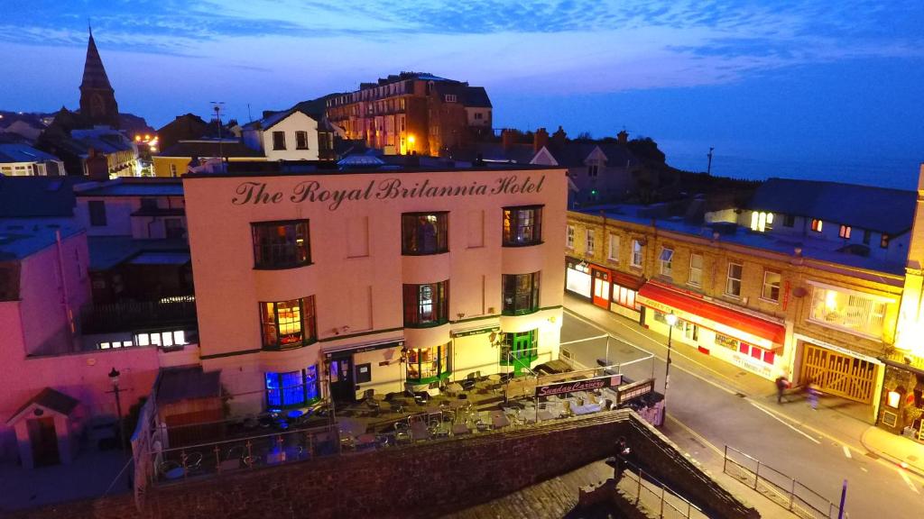 a building with a sign on top of it at night at Royal Britannia Hotel in Ilfracombe