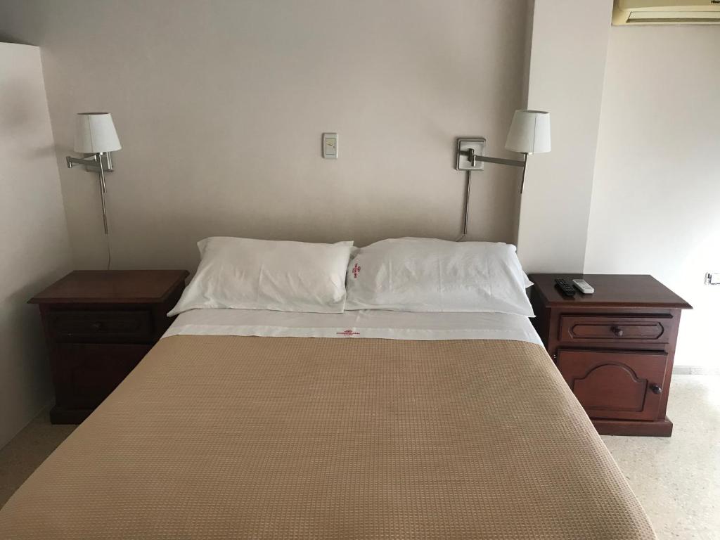 Postel nebo postele na pokoji v ubytování Cordoba Inn Apart Hotel