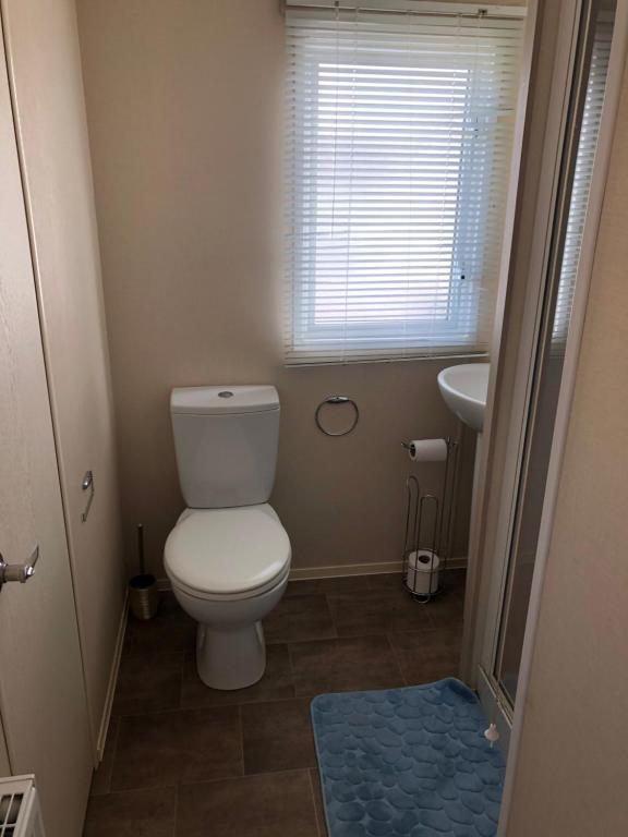 a small bathroom with a toilet and a sink at Marton mere in Blackpool