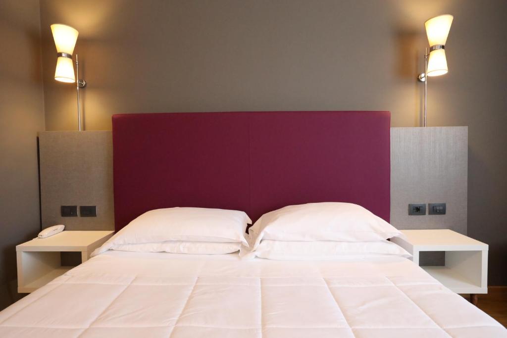 Postel nebo postele na pokoji v ubytování Hotel Umbria