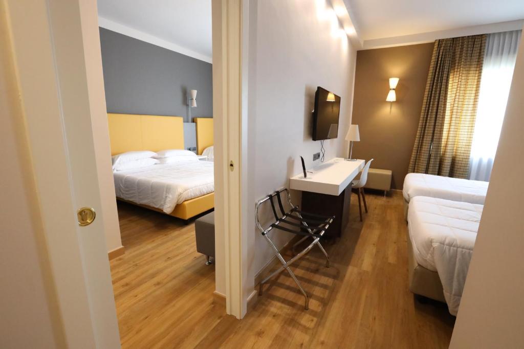 Postel nebo postele na pokoji v ubytování Hotel Umbria