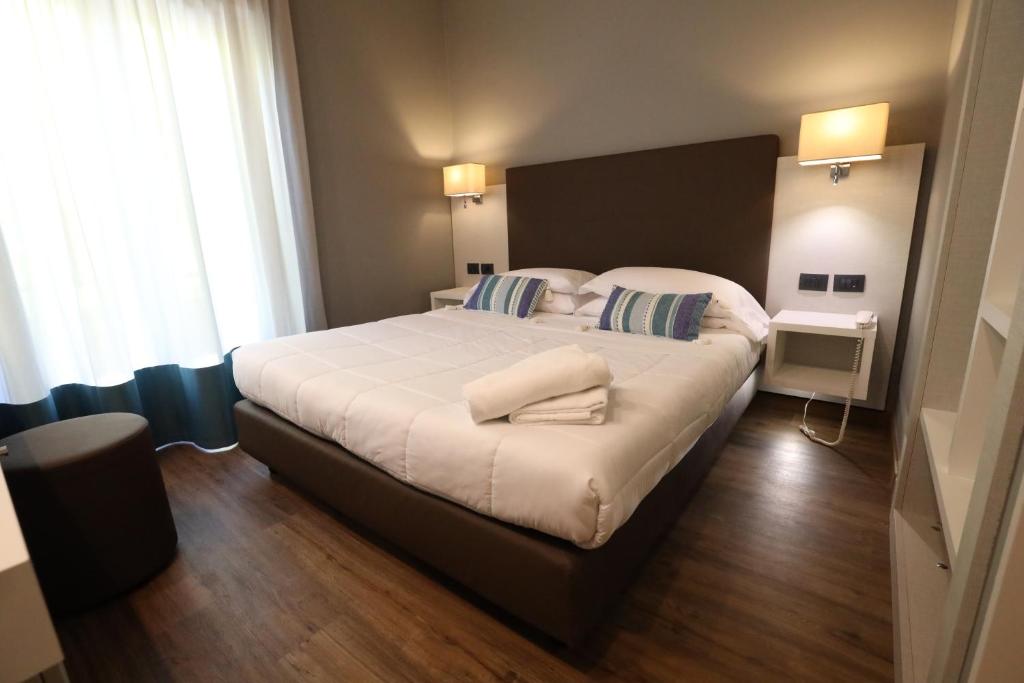 Postel nebo postele na pokoji v ubytování Hotel Umbria