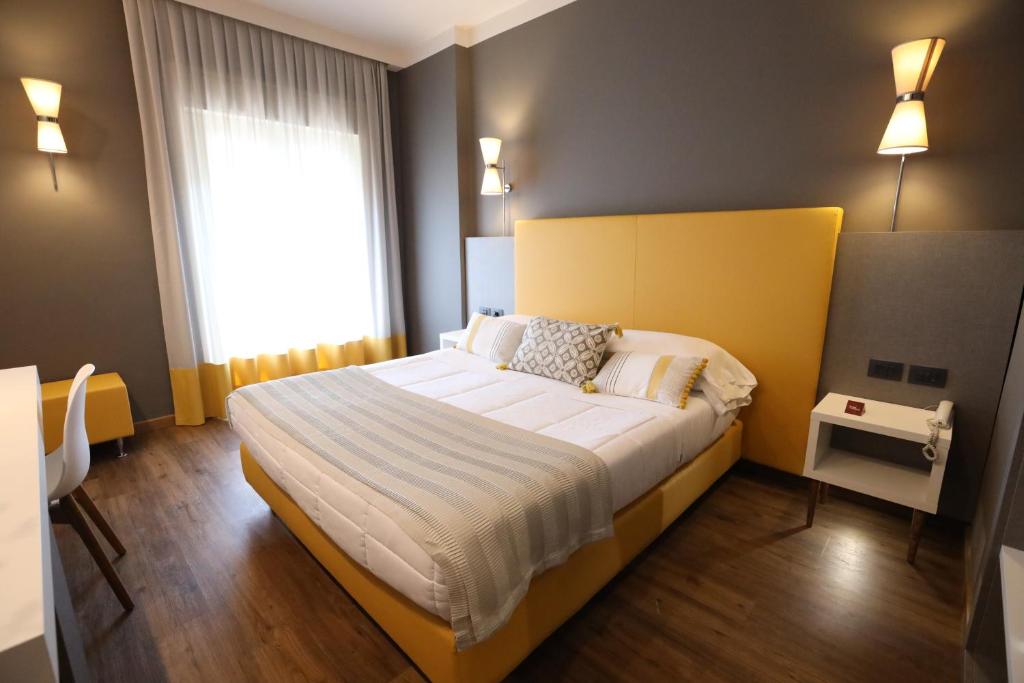 Postel nebo postele na pokoji v ubytování Hotel Umbria