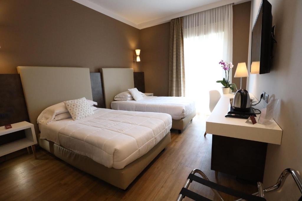 Postel nebo postele na pokoji v ubytování Hotel Umbria