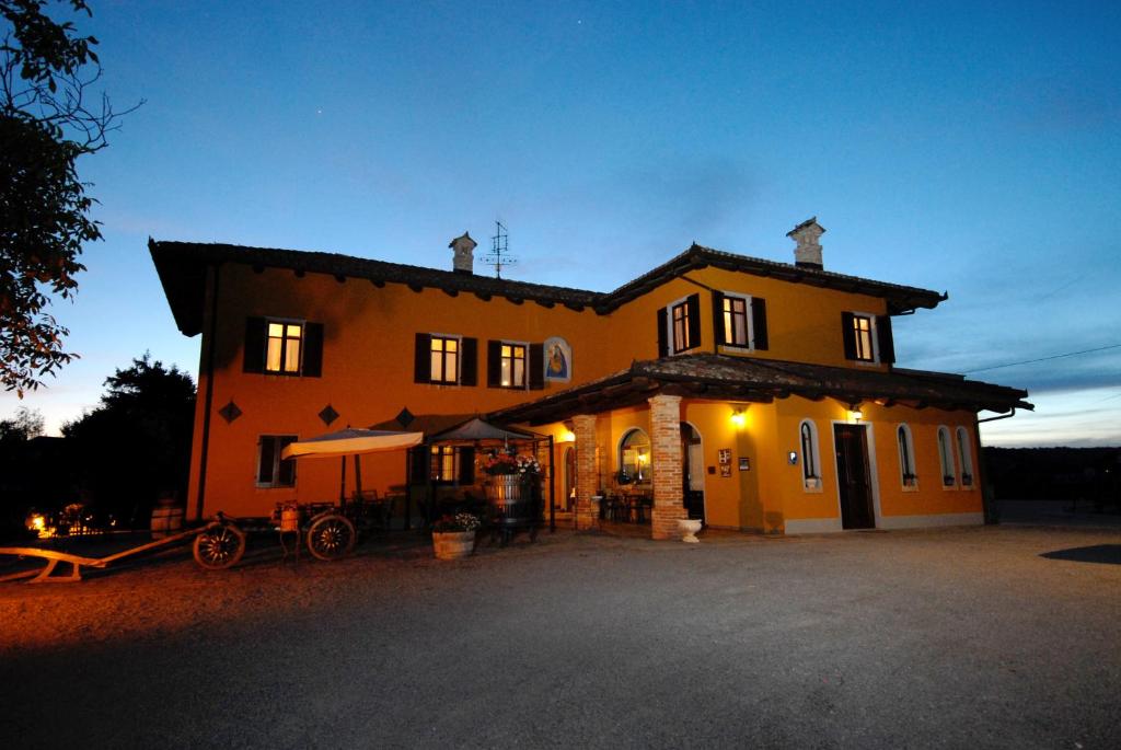 una casa grande de color naranja con planta Aveth en Agriturismo Ca' Brusà en Monforte dʼAlba