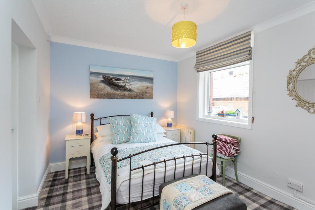 a bedroom with a bed and a window at Beach Hideaway in Lytham St Annes