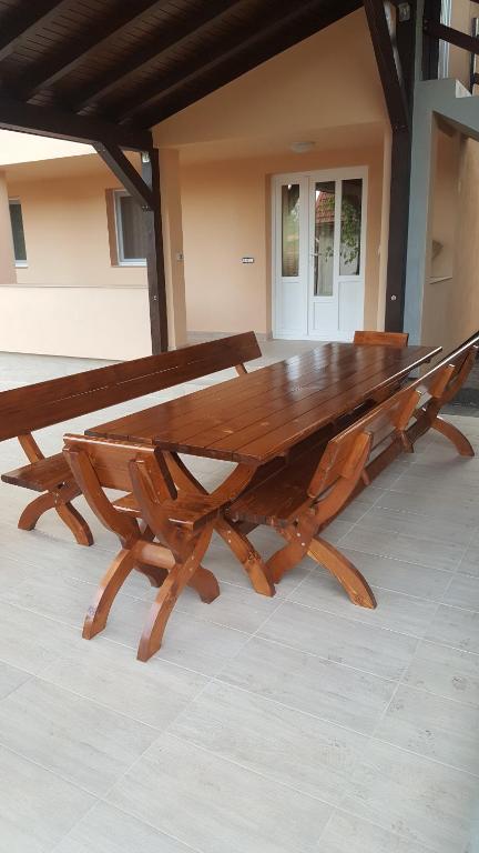 a large wooden table sitting on top of a floor at La Bustea in Hărţăgani