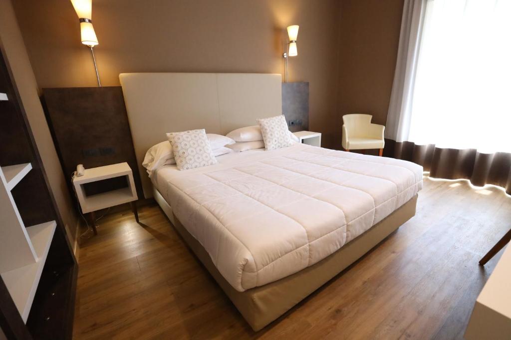 Postel nebo postele na pokoji v ubytování Hotel Umbria