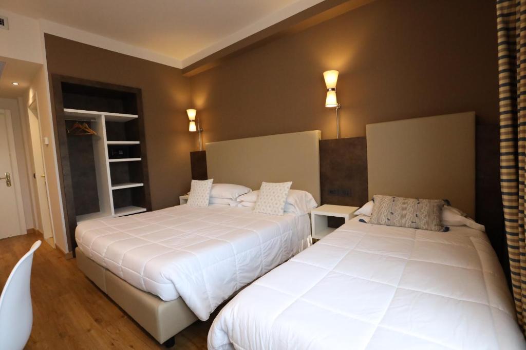 Postel nebo postele na pokoji v ubytování Hotel Umbria