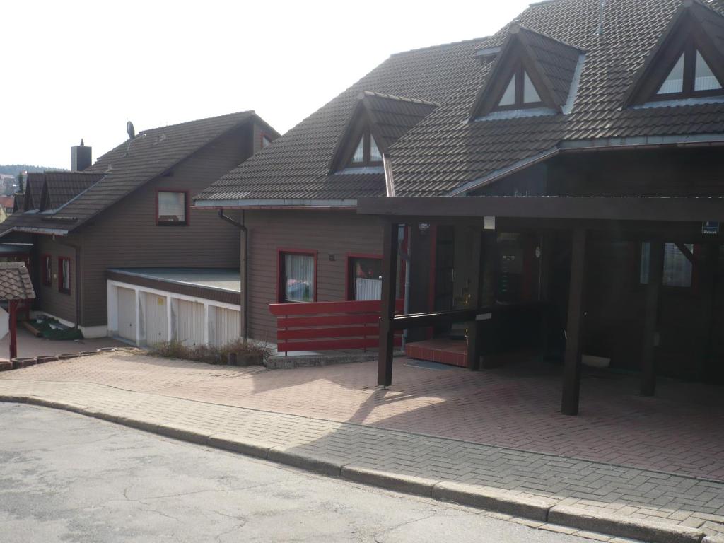 a house with a red bench in front of it at Ferienwohnung Fernblick in Sankt Andreasberg