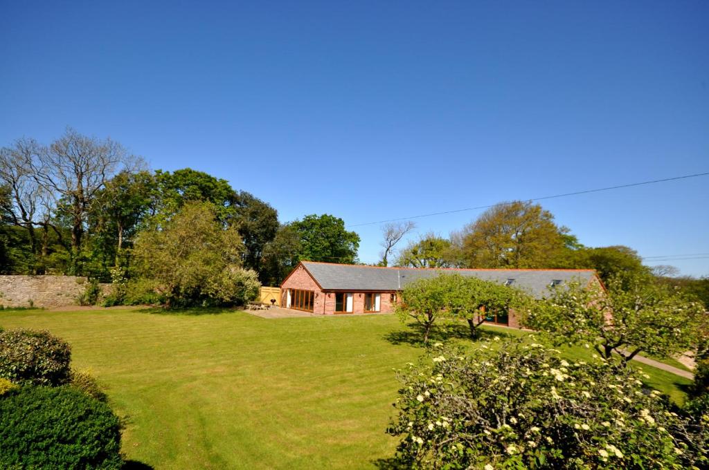 a house in the middle of a grassy yard at Moulton-Barrett Barn in Bideford