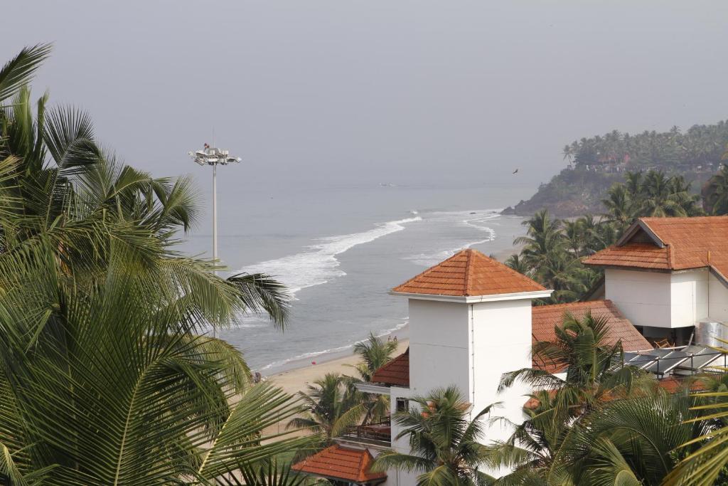 a view of a beach with houses and the ocean at Omsam Guest Home in Varkala