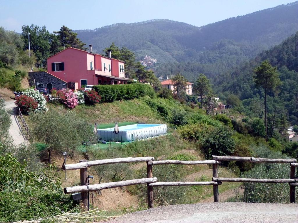 a house on the side of a hill with a pool at Agriturismo La Quiete in Levanto