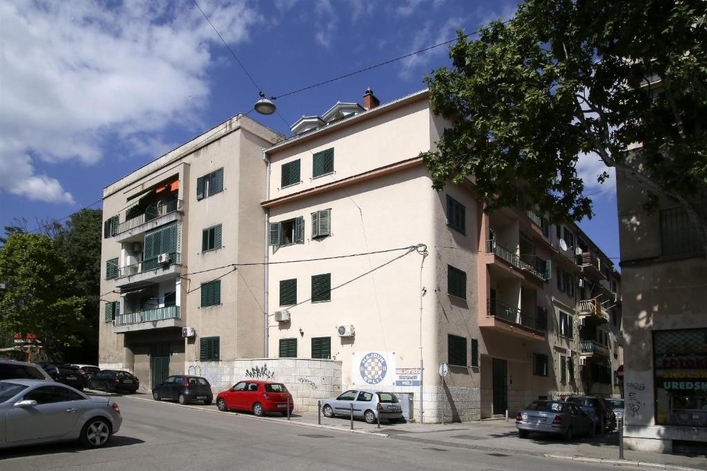 a white building with cars parked in front of it at Apartment Andelina in Split