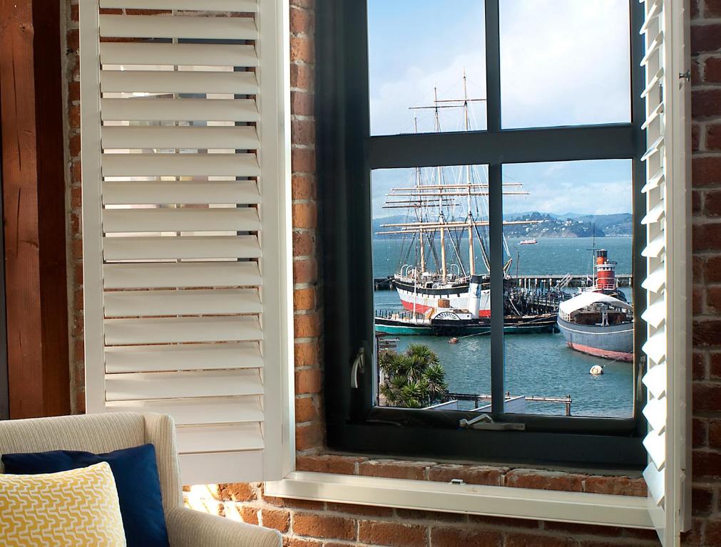 a window with a view of a harbor with boats at Argonaut Hotel, a Noble House Hotel in San Francisco