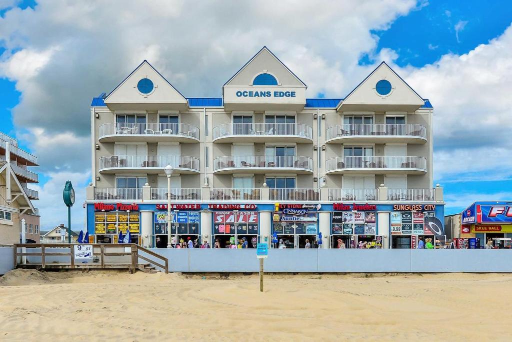 a hotel on the beach in front of a building at Ocean'S Edge 401 Condo in Ocean City