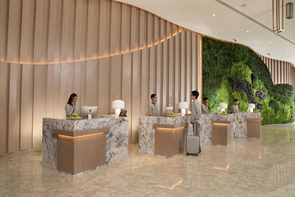 a rendering of a lobby with people sitting at tables at Capri by Fraser Johor Bahru in Johor Bahru
